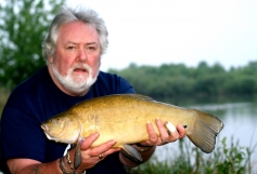 Bailiff Peter Tuke with a near 7lb Tench during a carp session on the Abbots Salford Lake 2013.