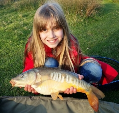 Harmonie, daughter of club member Aaron (Azz) Newitt with a plump carp wich fell to ledgered maggot at Alvechurch pool. 14/04/14.